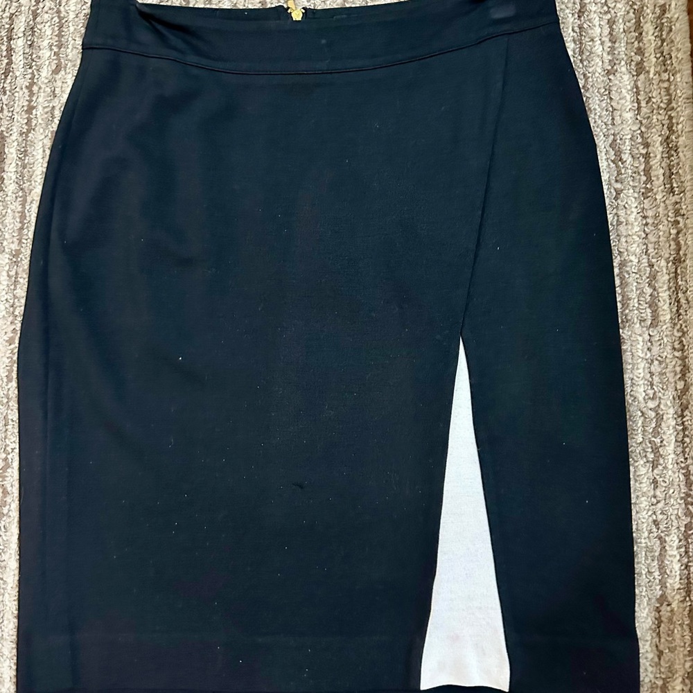 Black and white kick straight skirt with bold gold back zipper.